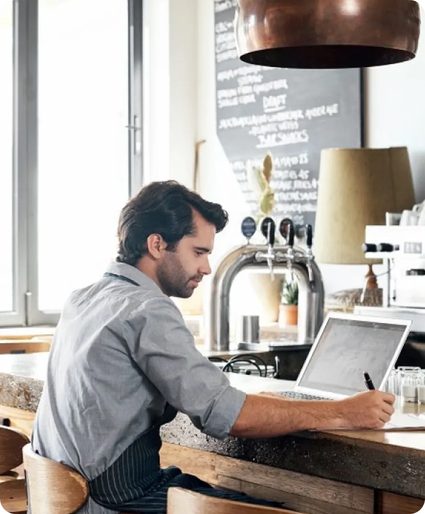 A restaurant owner working at the counter